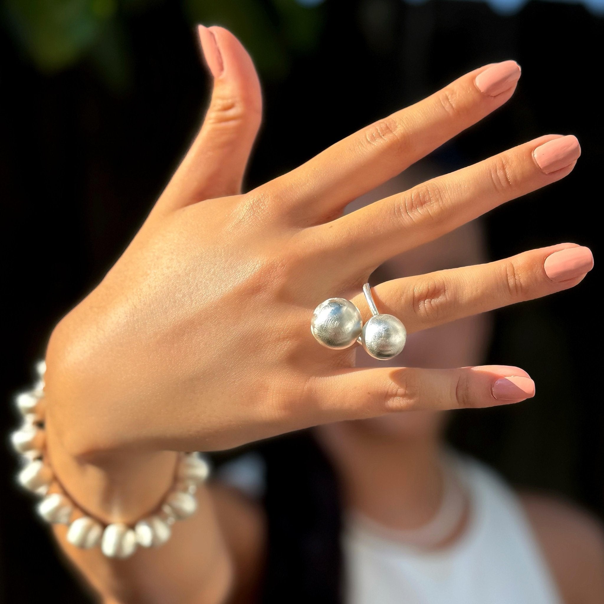 Nahaufnahme einer Hand mit Lumina Double Sphere Silberrings von Cosytas