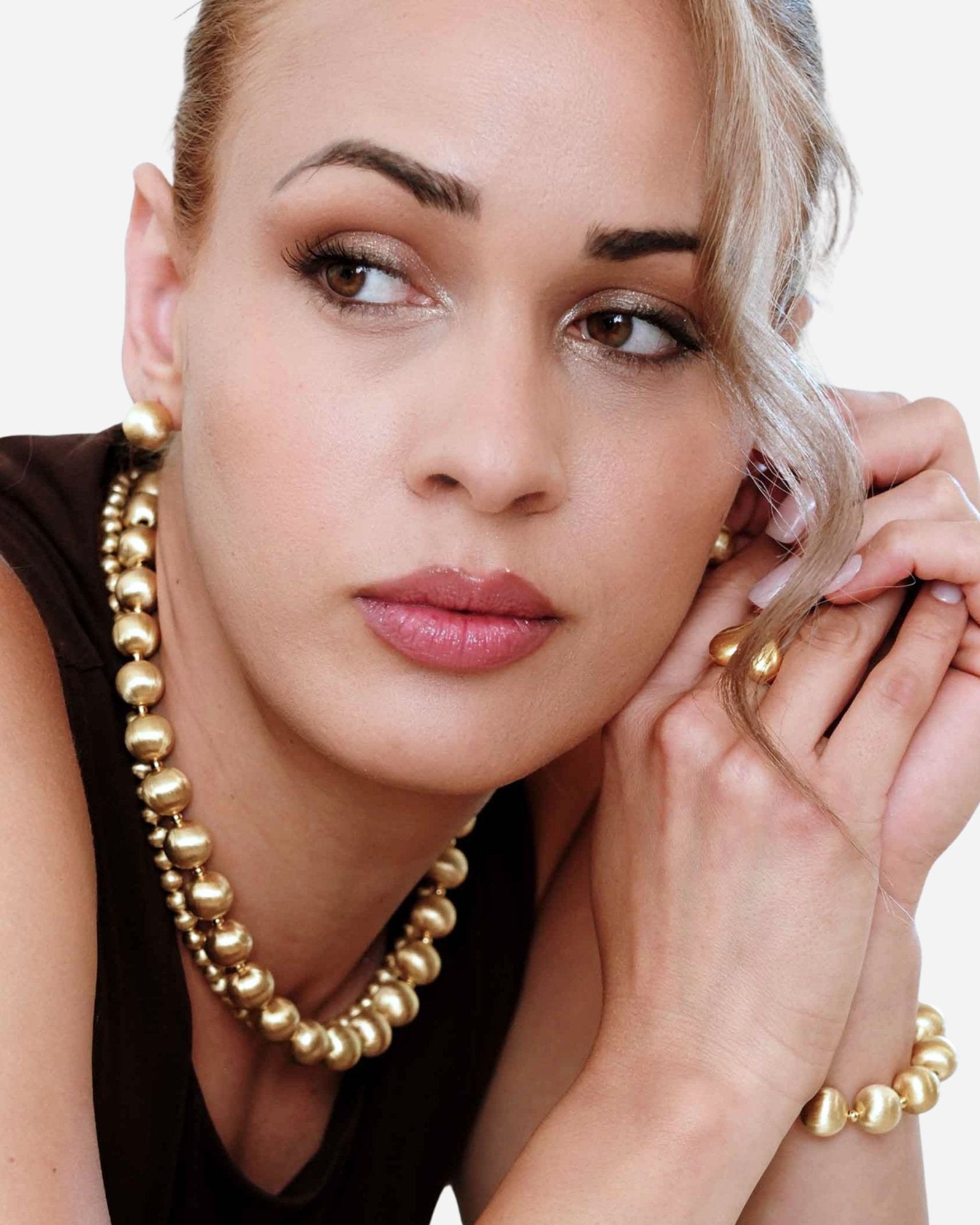 Modell trägt die Lumina Gold Sphere Halskette mit gebürsteten 18k vergoldete Goldkugeln in eleganter Nahaufnahme.